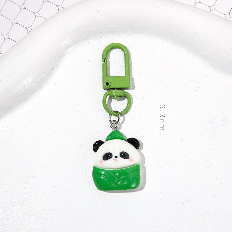 4 slumpmässiga söta panda-nyckelringar i tecknad stil